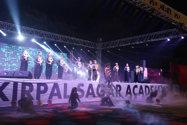 The stage ensemble performing with trident props