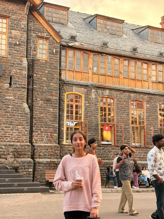 A shared moment outside a historic Shimla building