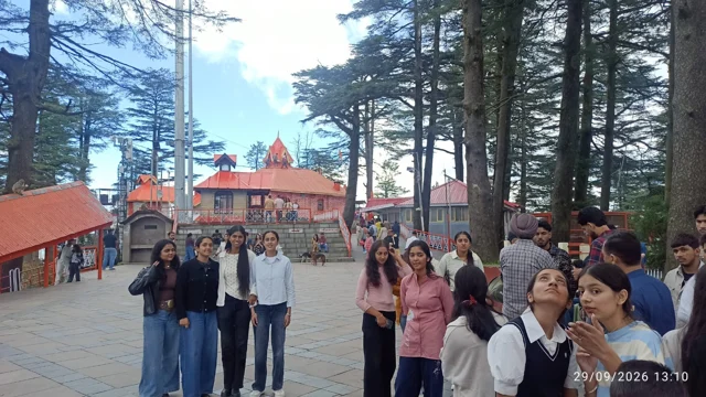 Students and staff exploring a wooded temple setting