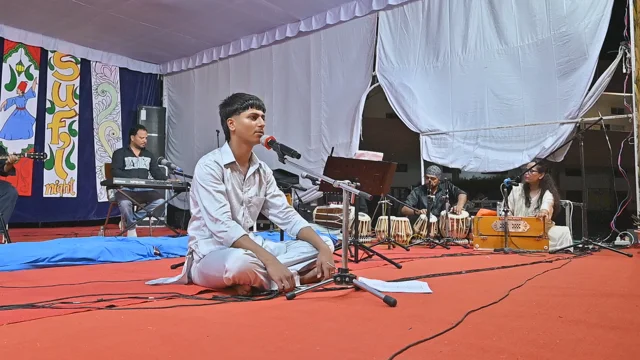 A student singing with musical accompaniment