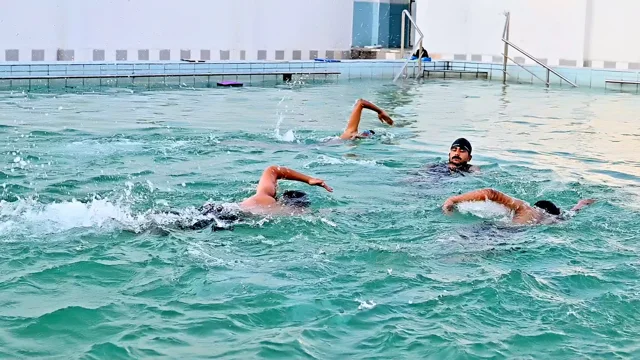 Students practising swimming strokes